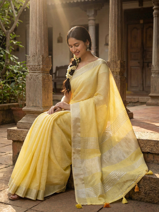 Sutriti Elegant Yellow Woven Linen Saree with Contrast Zari Border & Tassels – Soft & Breathable Party Wear