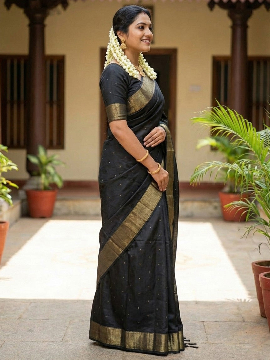 Black silk saree with gold zari border and horse motif pallu