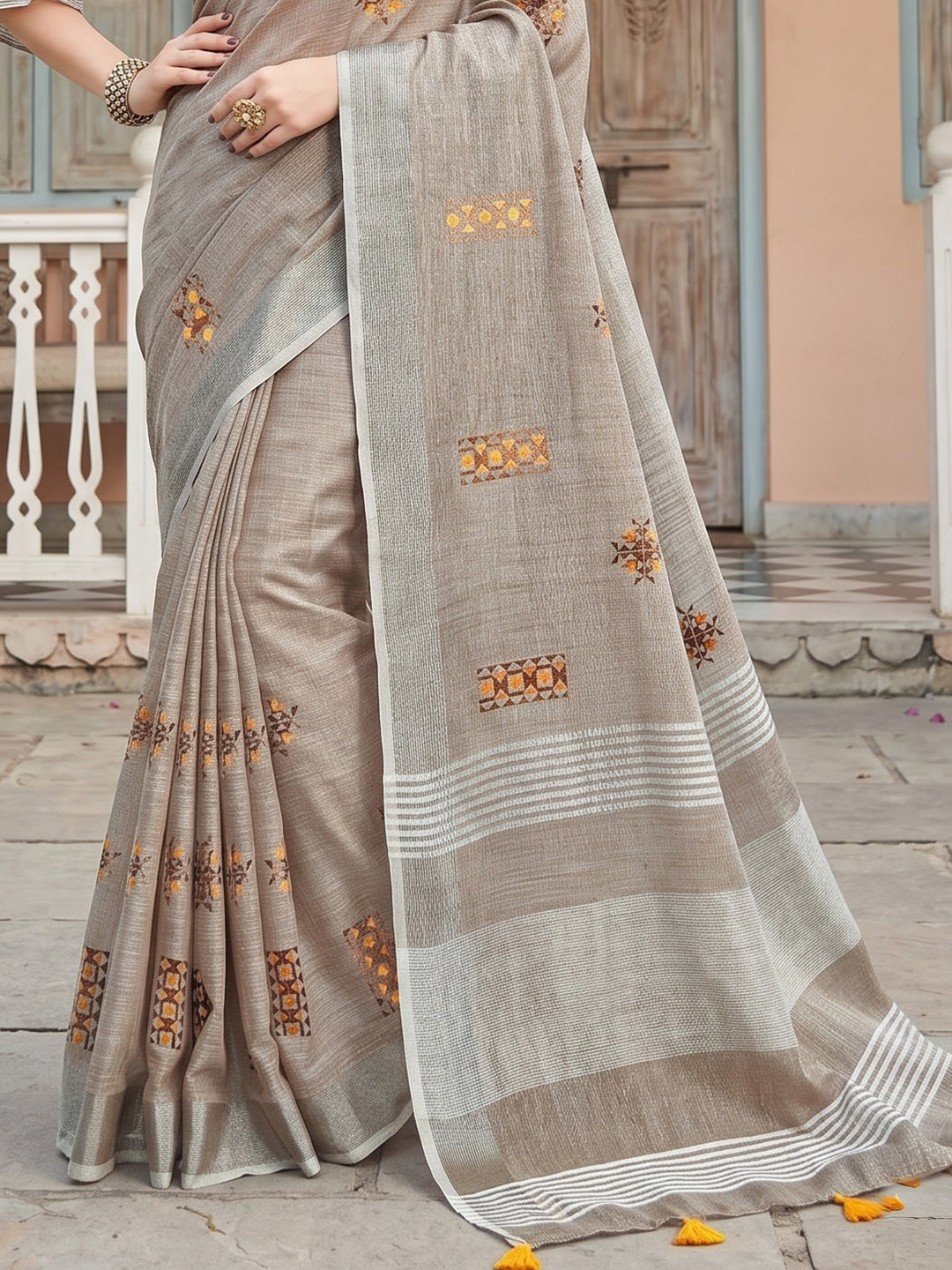 Sutriti Women Brown Linen Saree with Floral Embroidery Border & Tassels