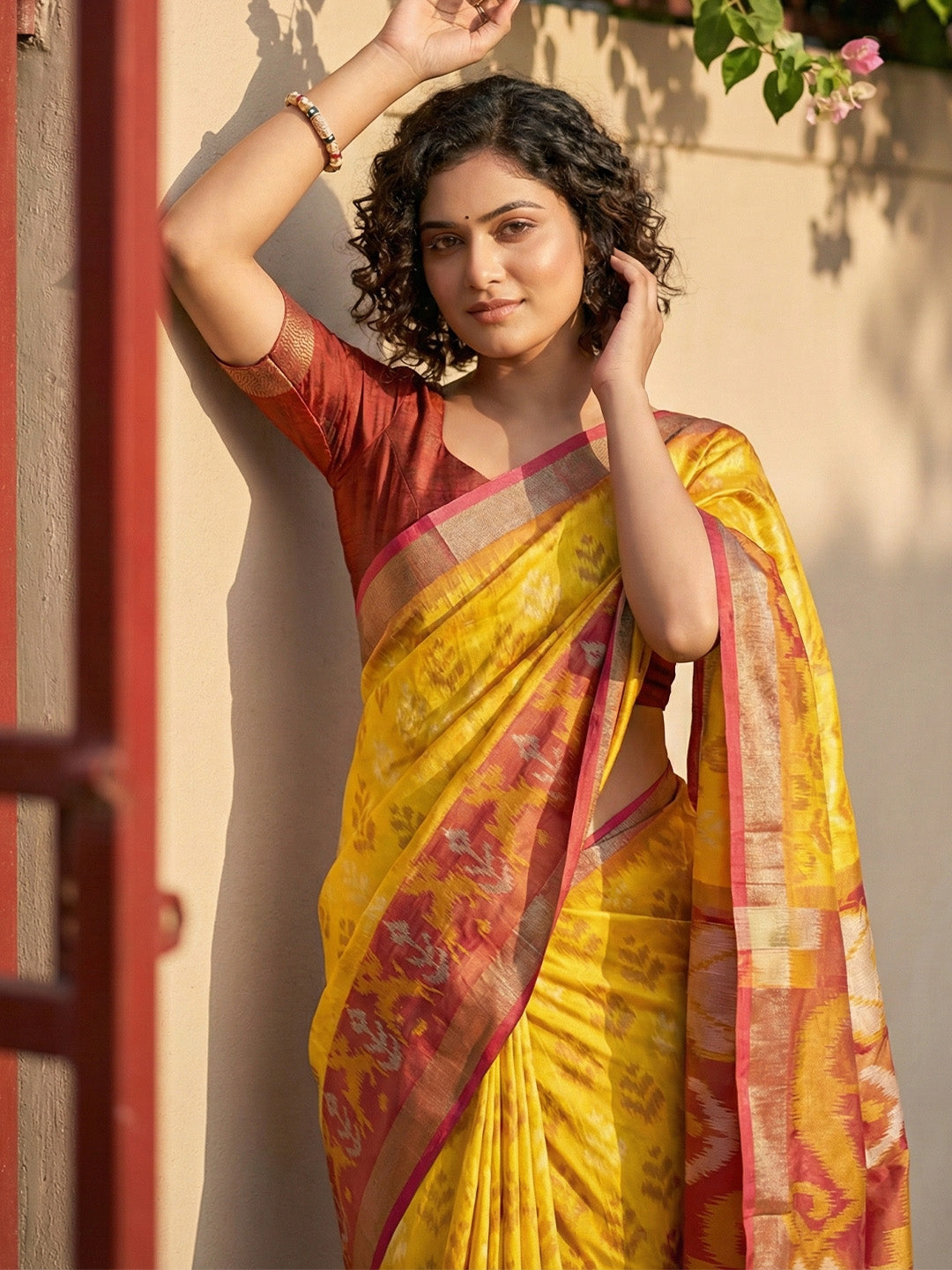 Mustard yellow Patola inspired woven saree with maroon contrast border and tassel pallu for women