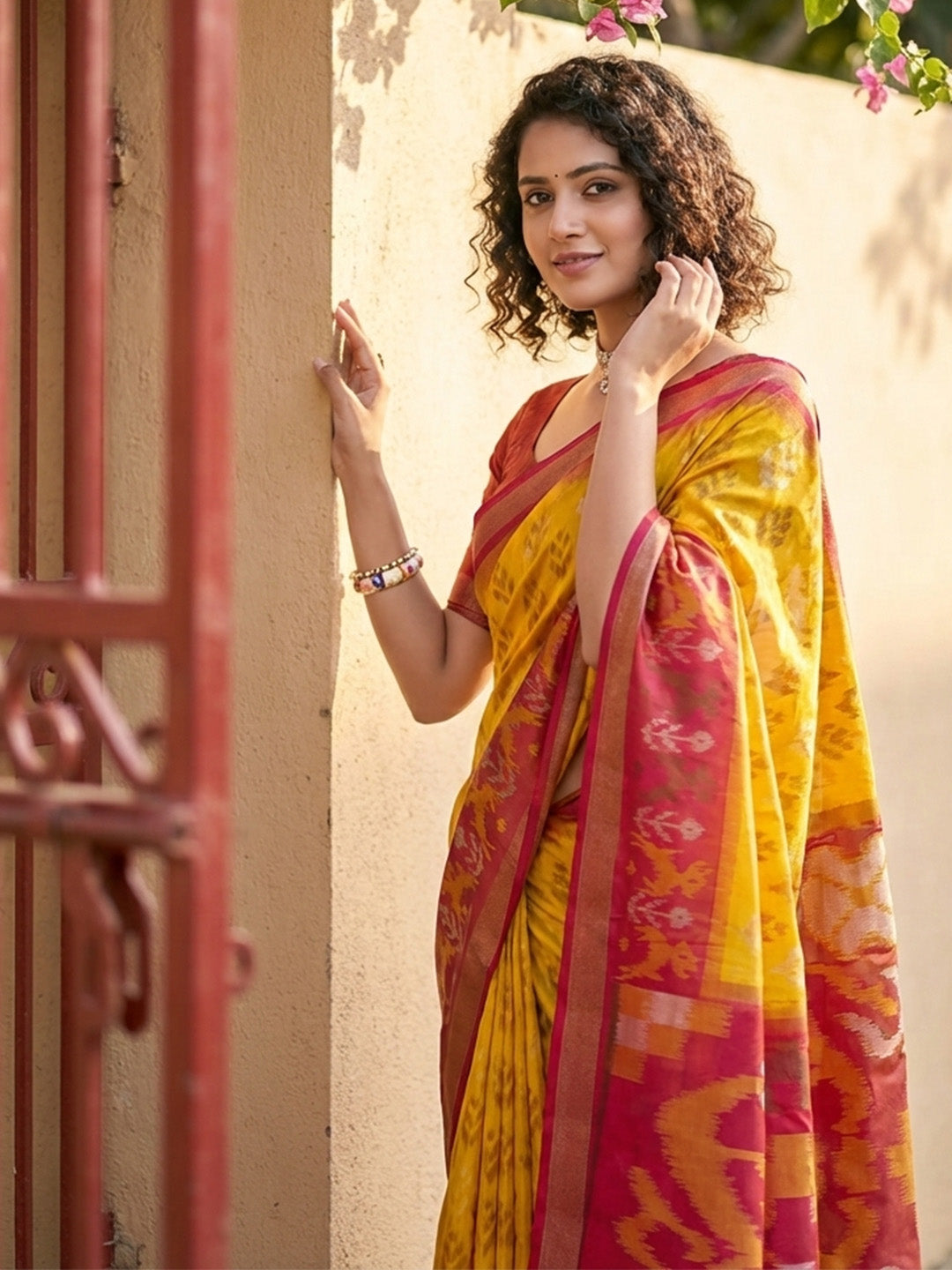 Mustard yellow Patola inspired woven saree with maroon contrast border and tassel pallu for women