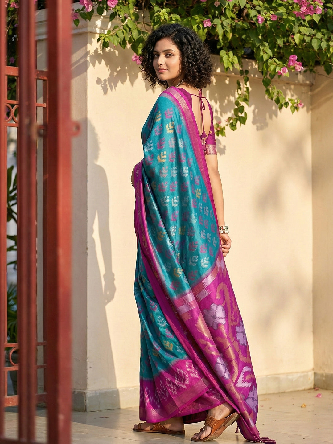 Teal blue Patola inspired woven saree with magenta contrast border and tassel pallu for festive wear