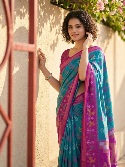 Teal blue Patola inspired woven saree with magenta contrast border and tassel pallu for festive wear