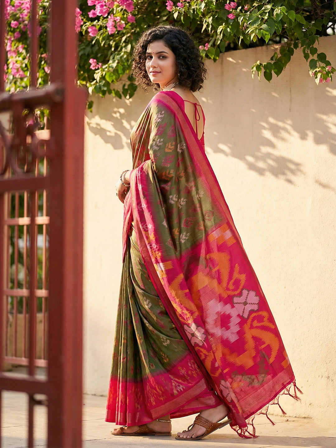 Olive green Patola inspired woven saree with rani pink contrast border and tassel pallu for women