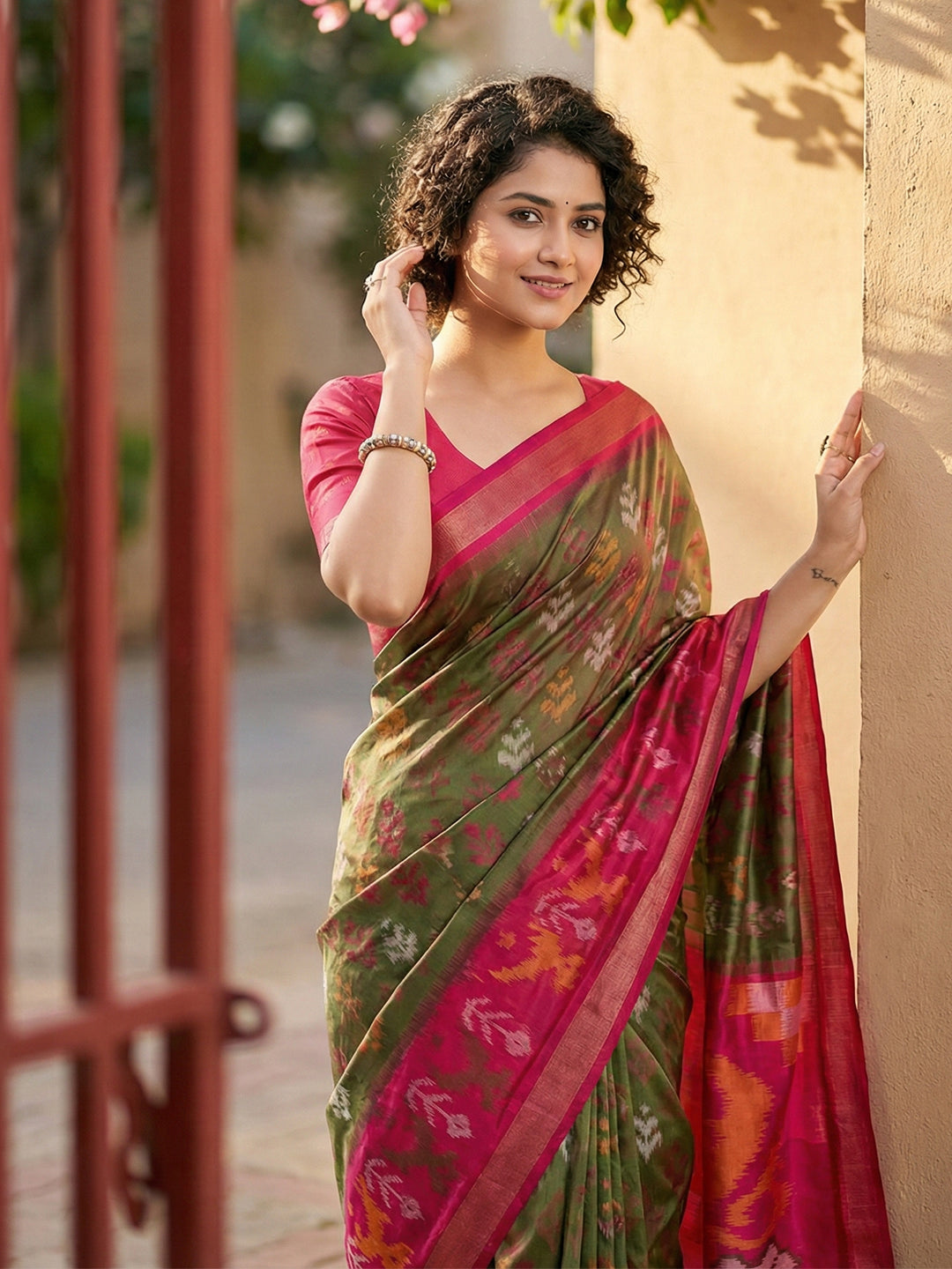 Olive green Patola inspired woven saree with rani pink contrast border and tassel pallu for women