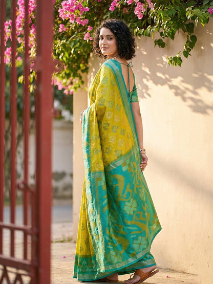 Lime yellow Patola inspired woven saree with teal contrast border and tassel pallu for festive wear