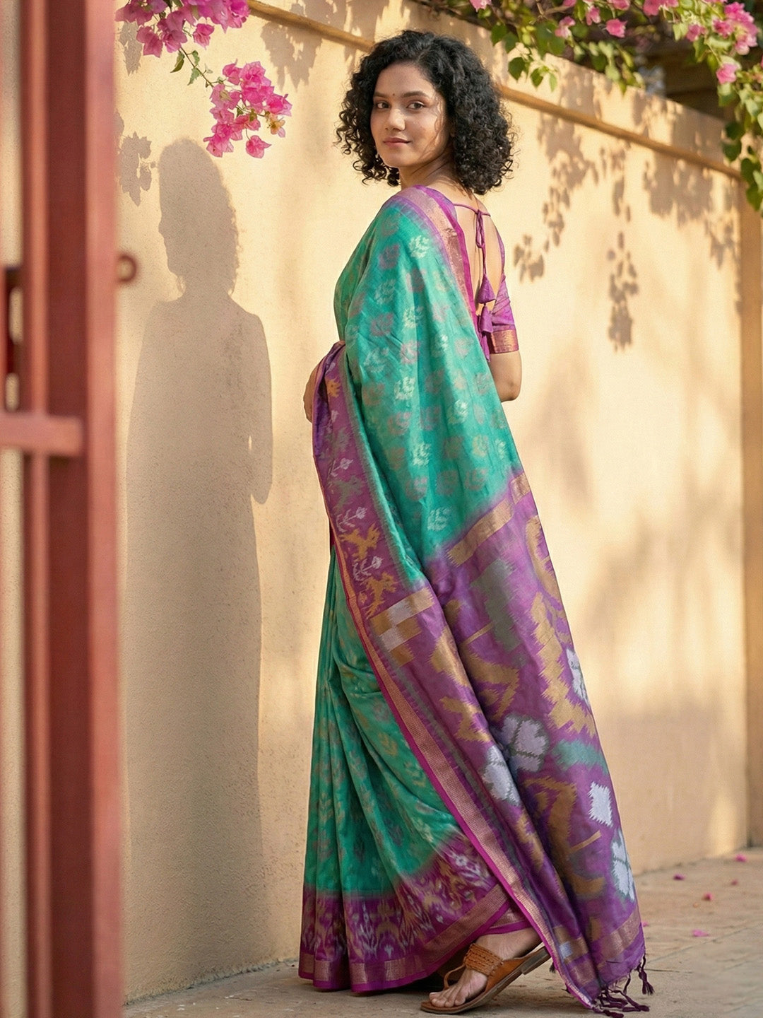 Sea green Patola inspired woven saree with purple contrast border and tassel pallu for festive wear