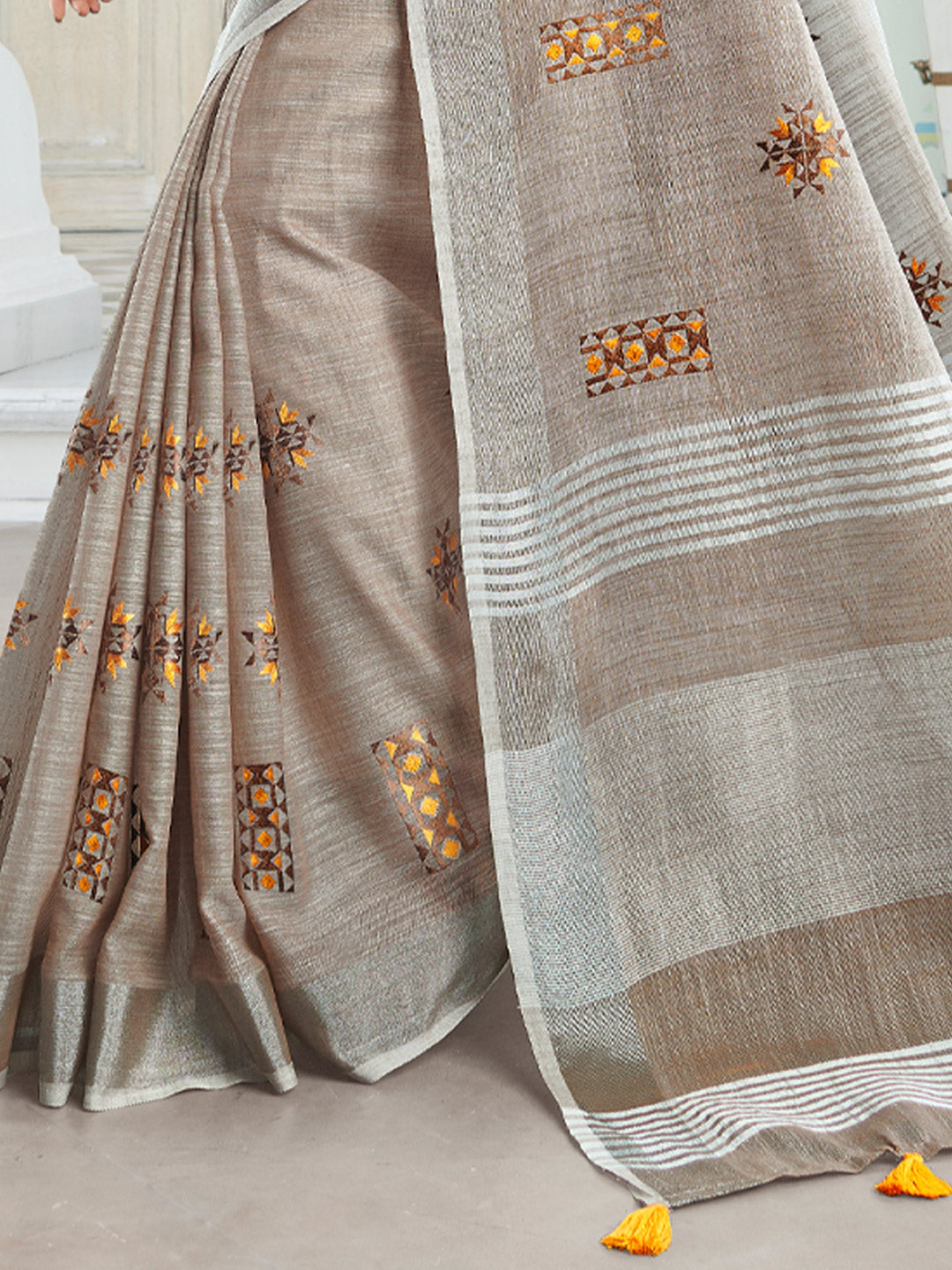 Sutriti Women Brown Linen Saree with Floral Embroidery Border & Tassels