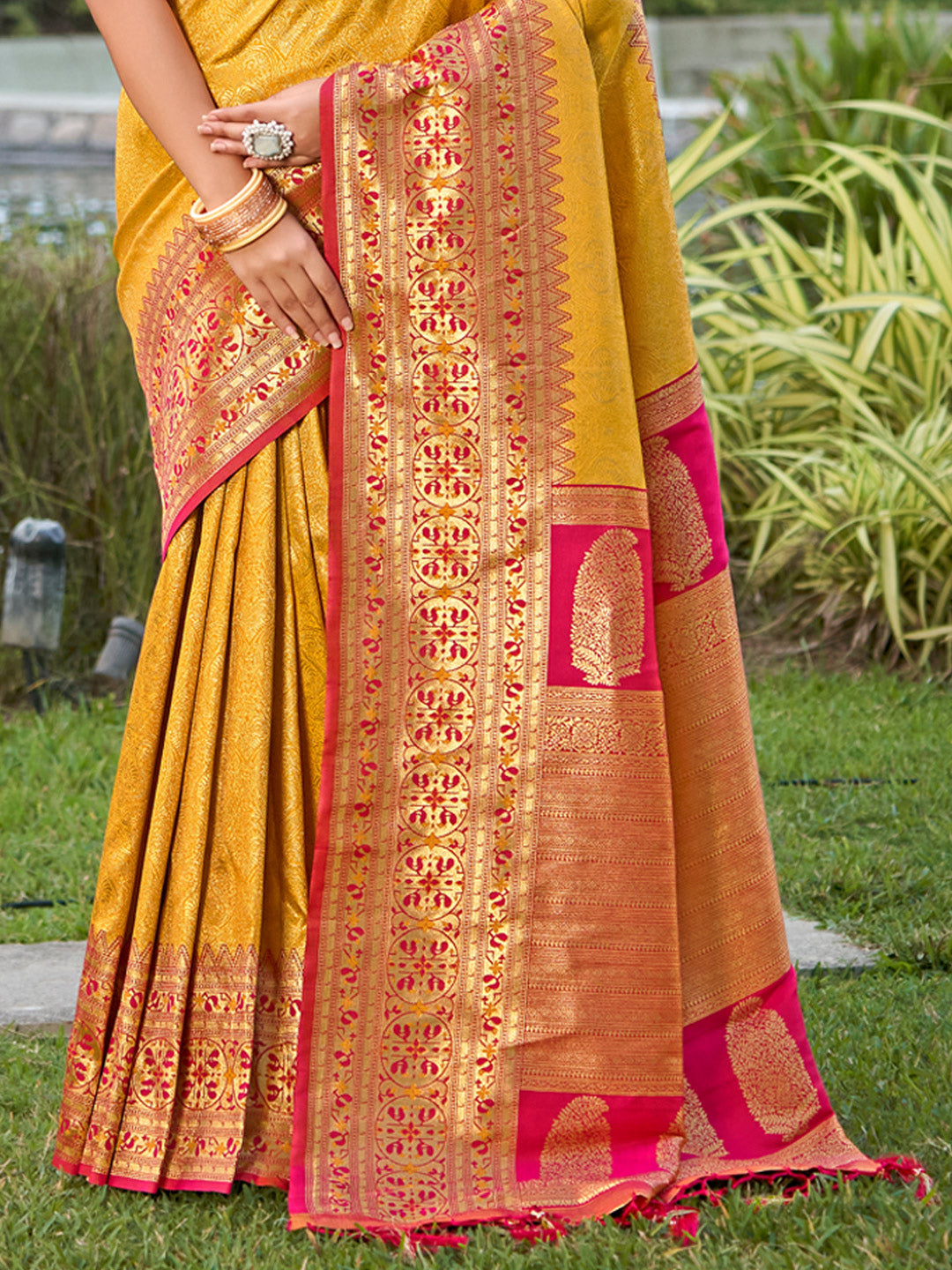 Golden mustard zari woven saree with pink contrast border and heavy pallu for women