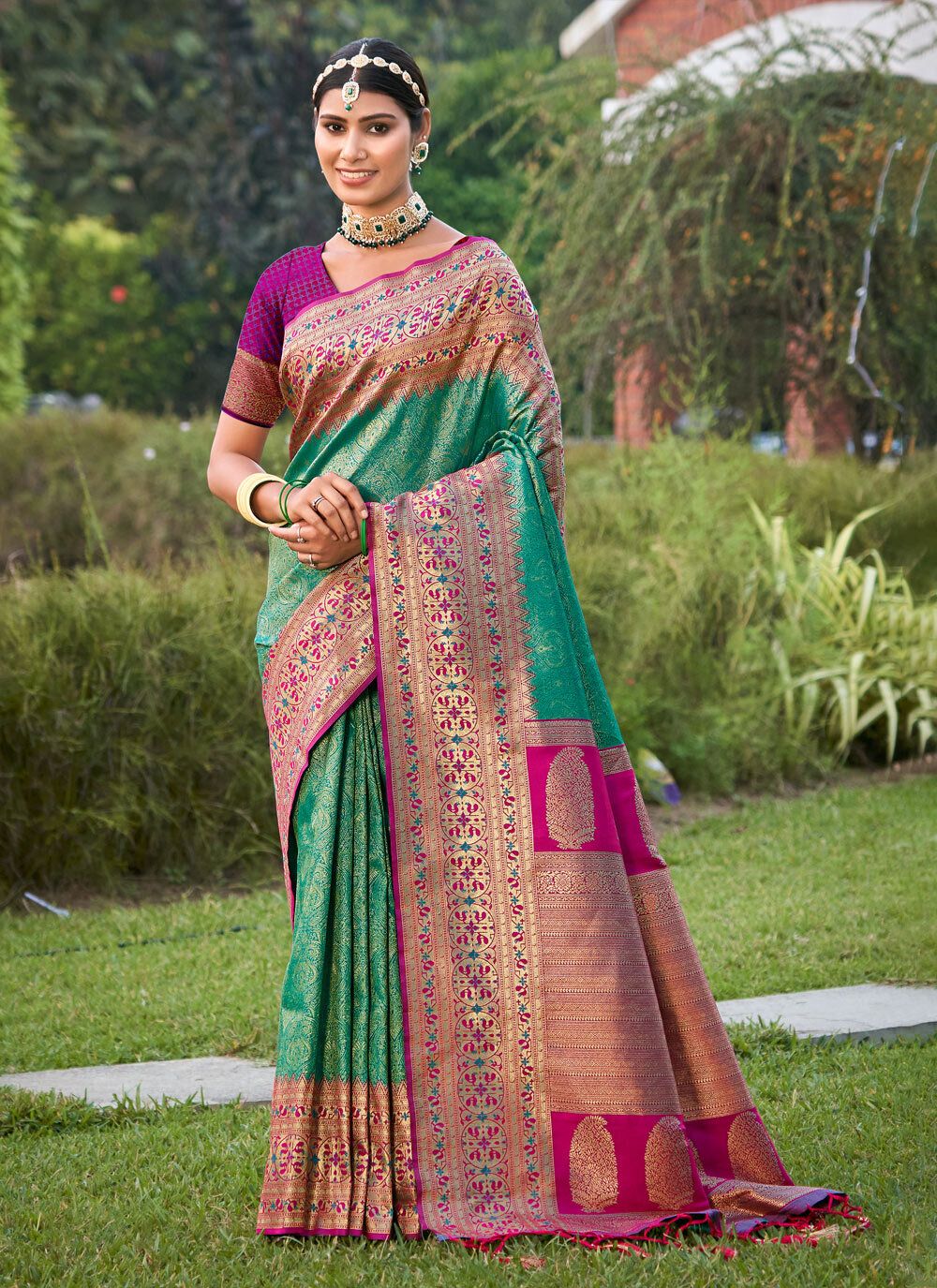 Emerald green zari woven saree for women with pink contrast border and heavy pallu