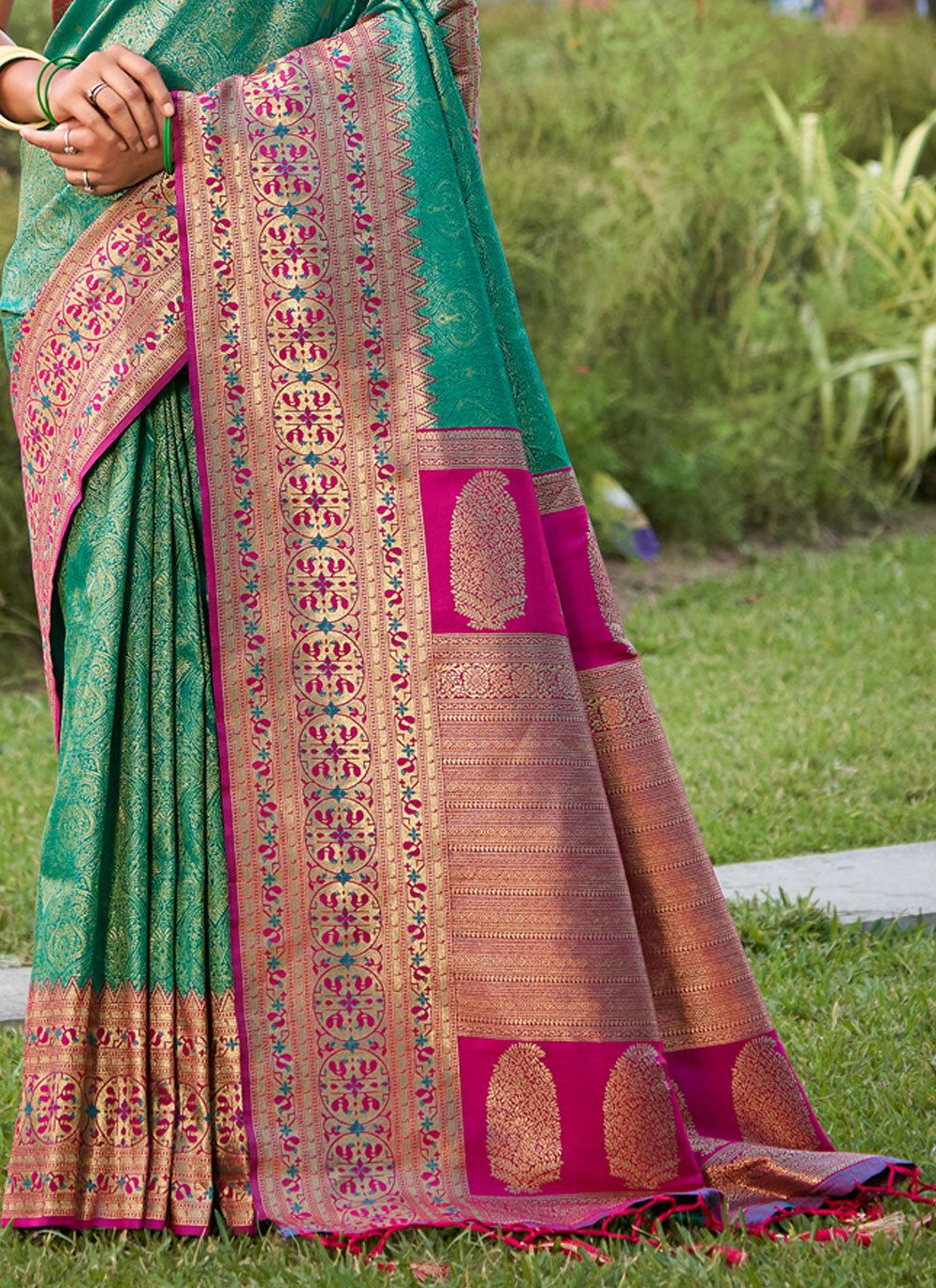 Emerald green zari woven saree for women with pink contrast border and heavy pallu