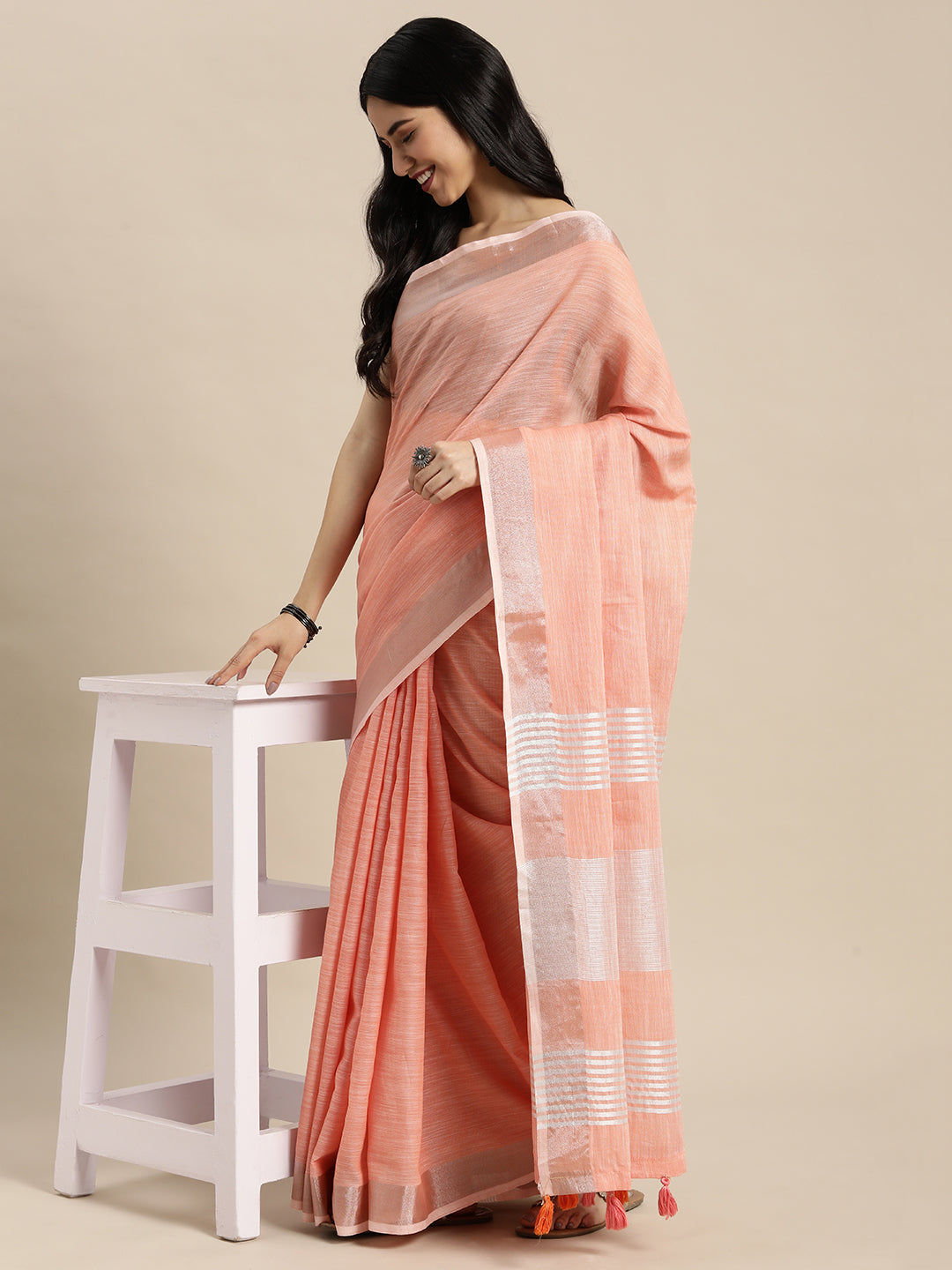 Sutriti Elegant Peach Woven Linen Saree with Contrast Zari Border & Tassels – Soft & Breathable Party Wear