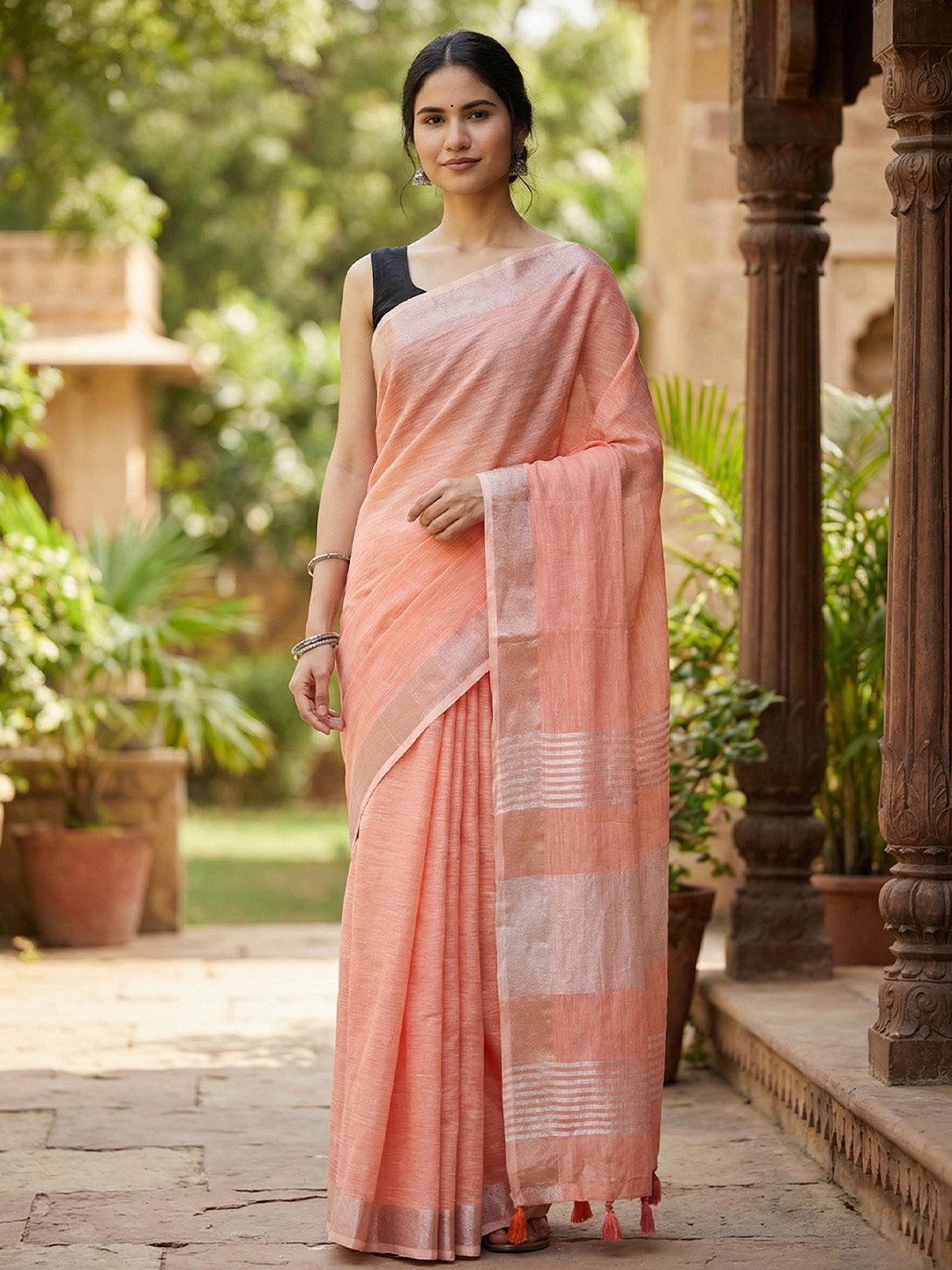 Sutriti Elegant Peach Woven Linen Saree with Contrast Zari Border & Tassels – Soft & Breathable Party Wear