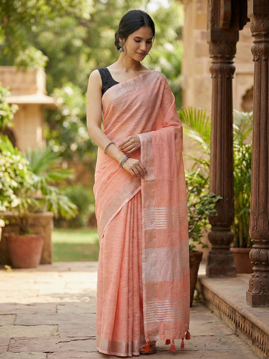 Sutriti Elegant Peach Woven Linen Saree with Contrast Zari Border & Tassels – Soft & Breathable Party Wear