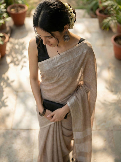 Sutriti Elegant Brown Woven Linen Saree with Contrast Zari Border & Tassels – Soft & Breathable Party Wear
