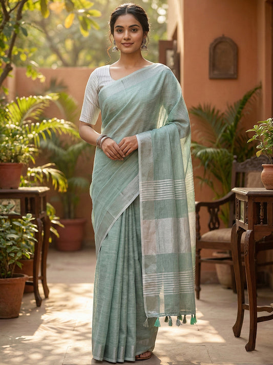 Sutriti Elegant Sea Green Woven Linen Saree with Contrast Zari Border & Tassels – Soft & Breathable Party Wear
