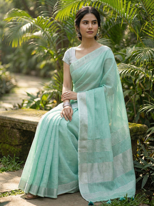 Sutriti Elegant Turquoise Woven Linen Saree with Contrast Zari Border & Tassels – Soft & Breathable Party Wear