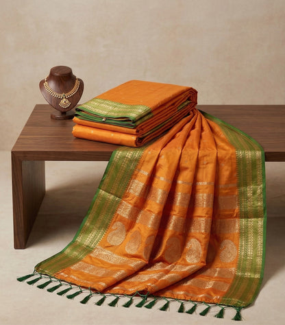 Sutriti The Sunset Glow: Vibrant Orange Soft Silk Saree with Contrast Green Zari Border