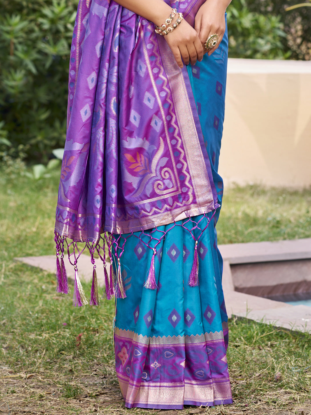 Teal blue woven saree for women with purple contrast border and tassel pallu