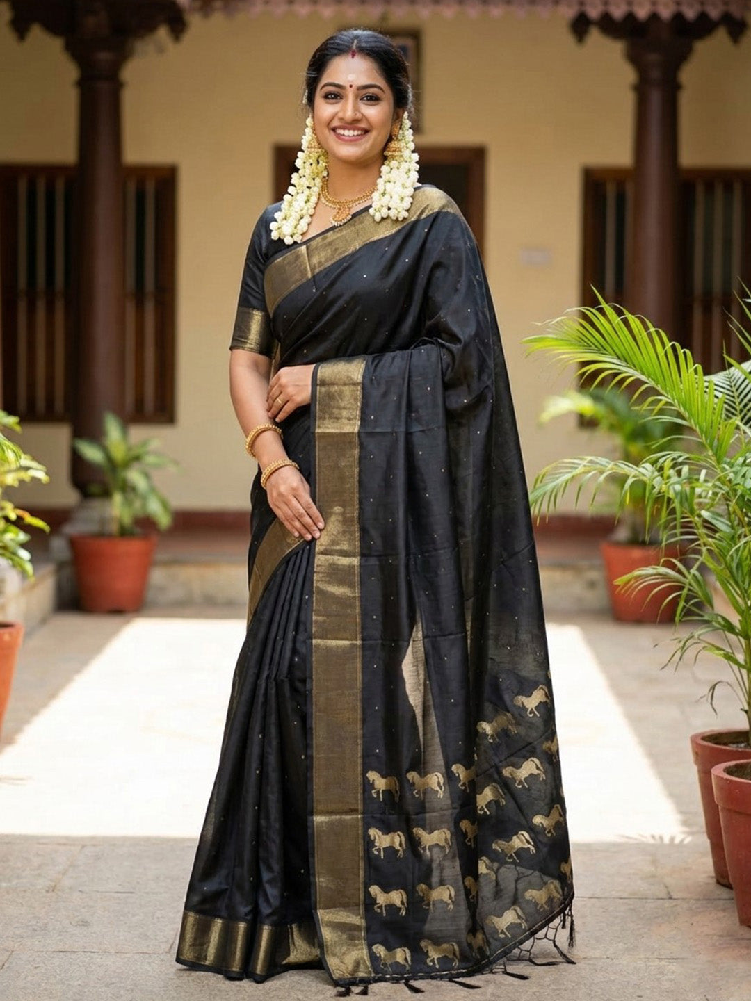 Black silk saree with gold zari border and horse motif pallu