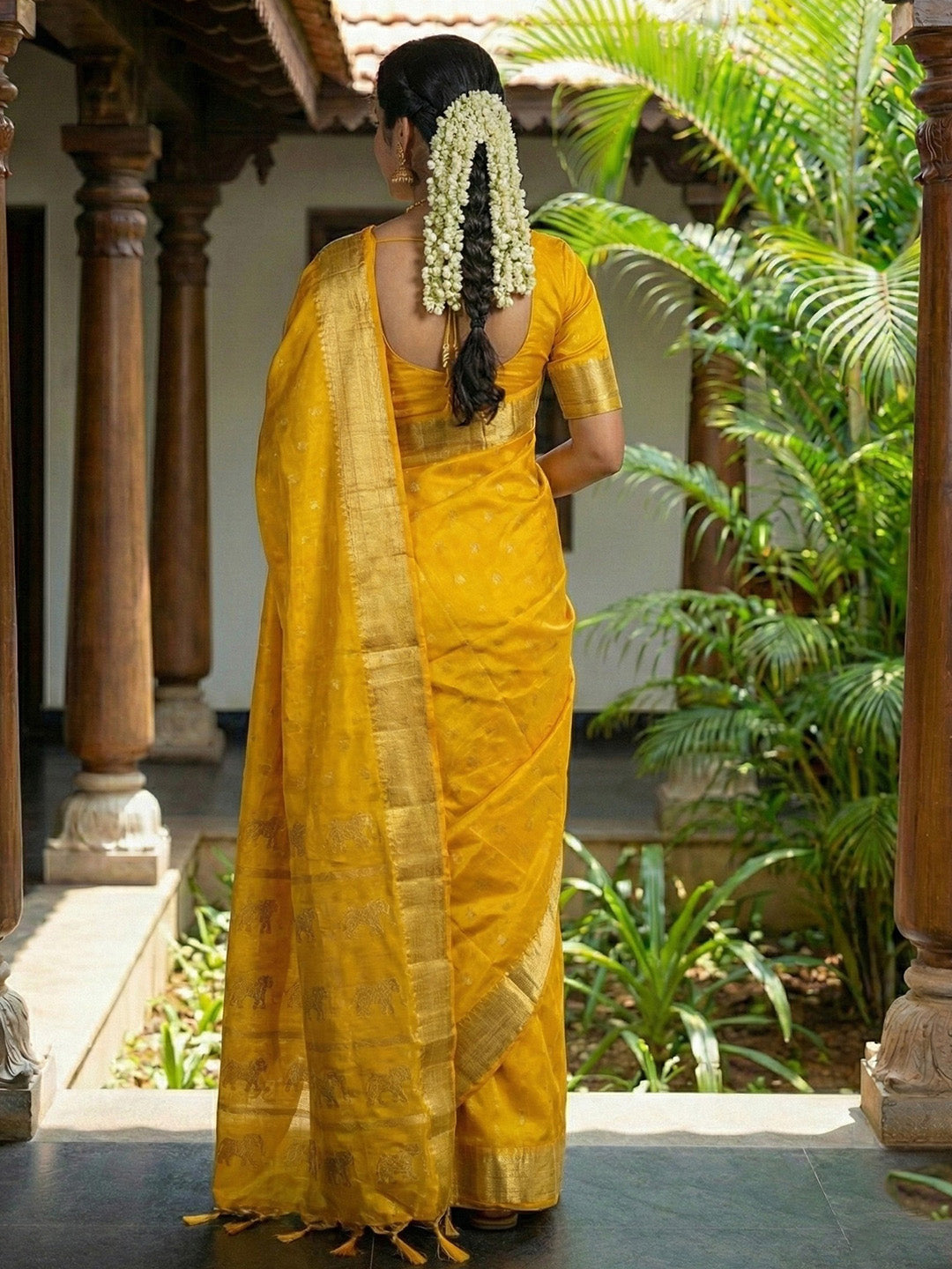 Mustard yellow silk saree with gold zari border and ethnic horse motif