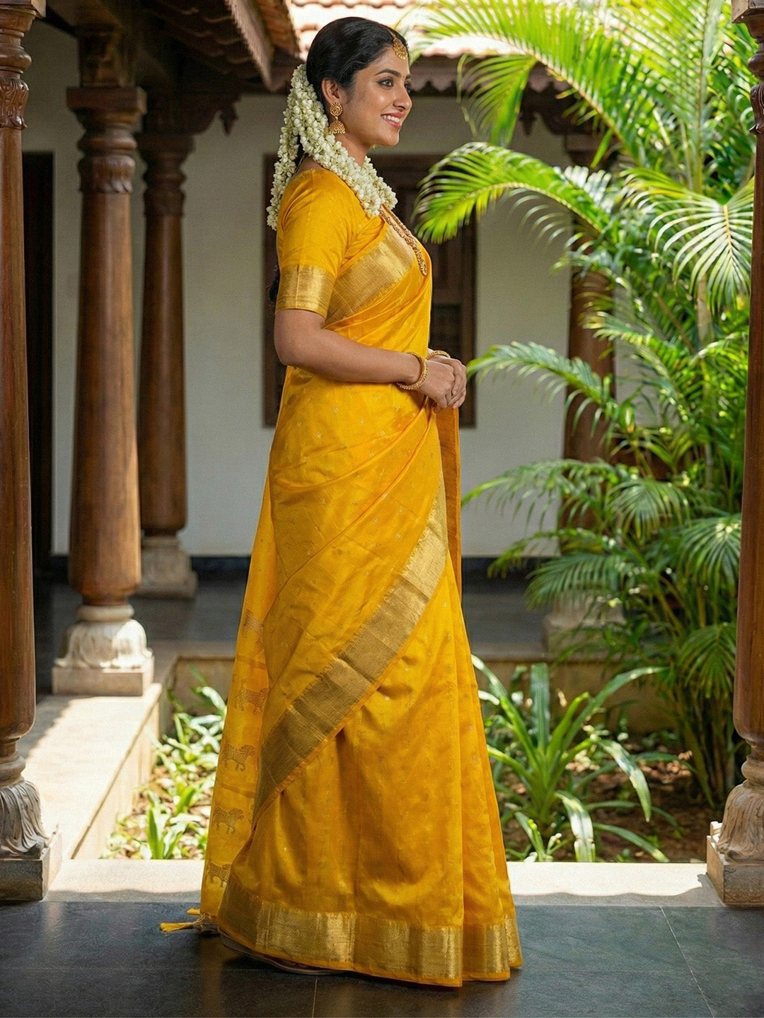 Mustard yellow silk saree with gold zari border and ethnic horse motif