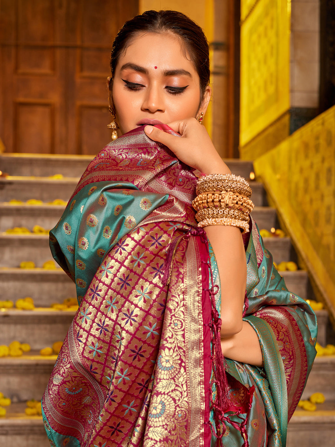 Teal green zari woven saree for women with magenta contrast border and rich pallu for wedding festive wear